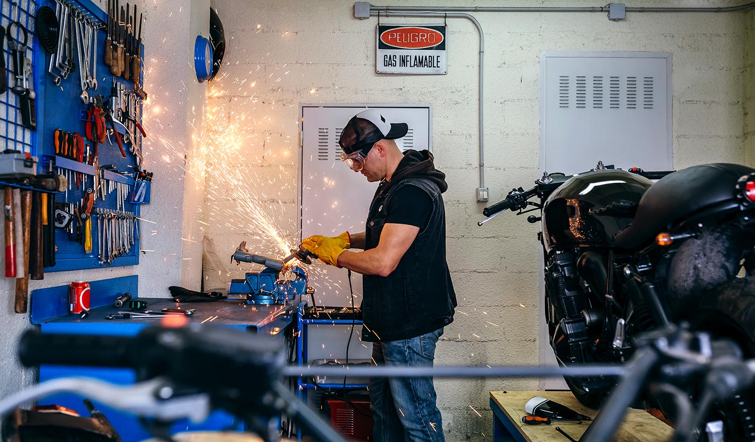 motorcycle-mechanic-using-a-grinder-B3JSF5V-resize.jpg